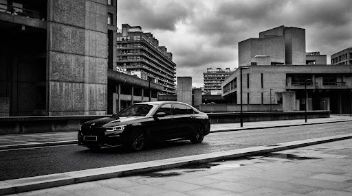A saloon car on a London street, illustrating private-hire travel